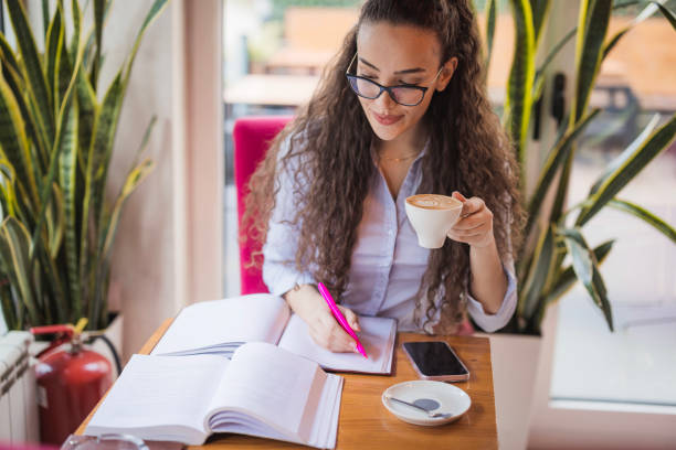 istock Young woman working during a coffee break 2170868225