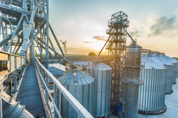 Panoramic view of industrial silos and grain storage facilities at sunset. elevator view from above