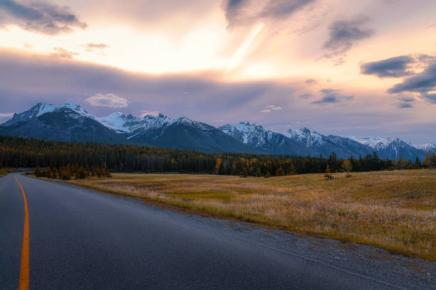 istock Sunrise Sky Glowing Over A Mountain Road In Banff 2170870360