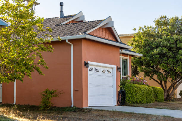 Front of a new neat modern single story family home with landscaped gardens, green grass and blue sky for copy space. Click to see more...