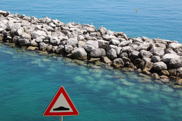Blue Ocean water with signage and flag on the Amalfi Coast