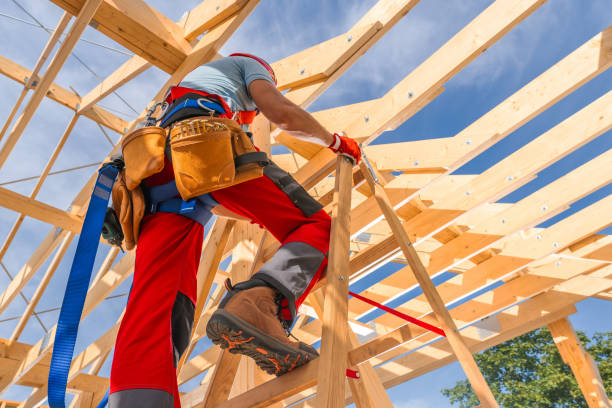 istock Construction Worker Climbing a Ladder Amid Wooden Framework on a Bright Sunny Day 2170874529