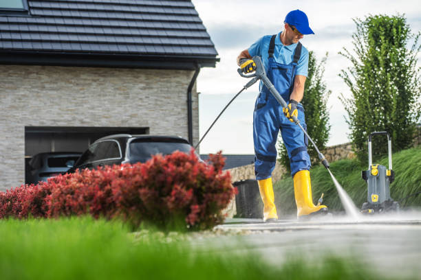 istock Man Using a Pressure Washer to Clean Driveway While Standing on a Sunny Afternoon 2170875464