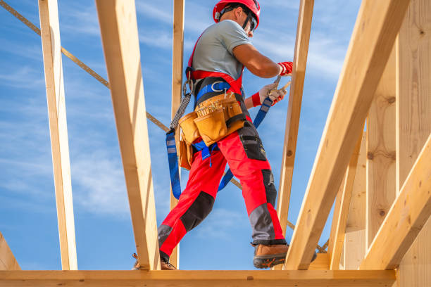 istock Construction Worker Walking on Wooden Rafters at a Building Site Under a Clear Blue Sky 2170875682