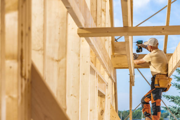 istock A Carpenter Works on a Wooden Framework of a House Under a Clear Blue Sky During Daylight 2170875705