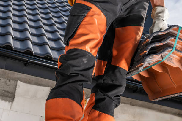 istock Construction Worker Carries Tiles While on a Roof During a Sunny Day at a Building Site 2170876464