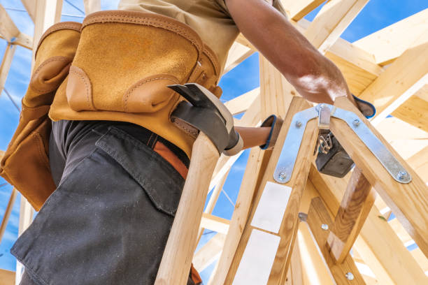 istock Construction Worker Using a Wooden Ladder to Build a Structure Under a Clear Blue Sky 2170876547