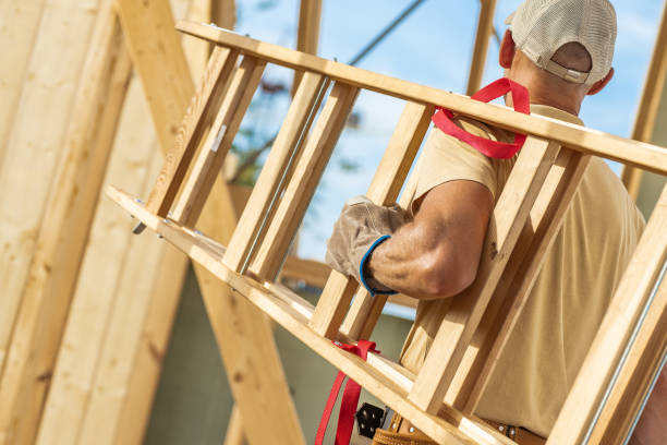 istock Construction Worker Carrying a Wooden Ladder Inside a Building Under Renovation on a Sunny Day 2170876764