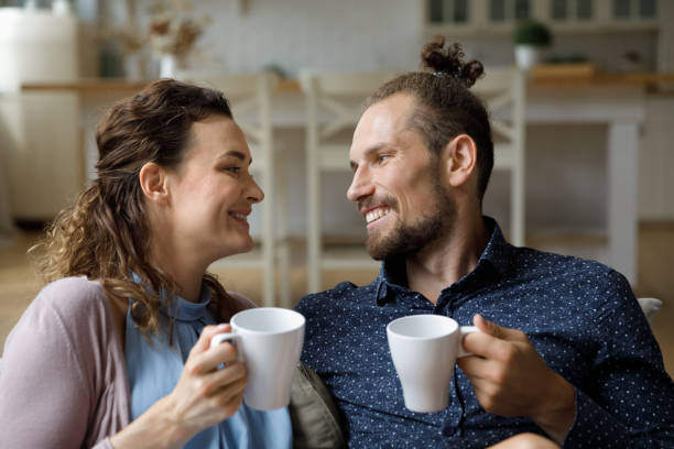 istock Happy cheerful married couple in love resting on sofa 2170877289