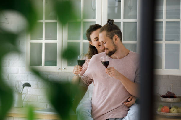 istock Happy cute young dating couple drinking wine, hugging 2170877357