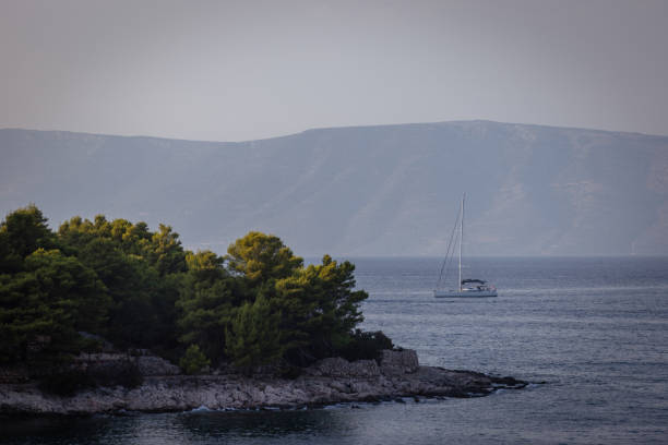 The boat is sailing on Adriatic Sea in cloudy weather.Hvar Island - Croatia.