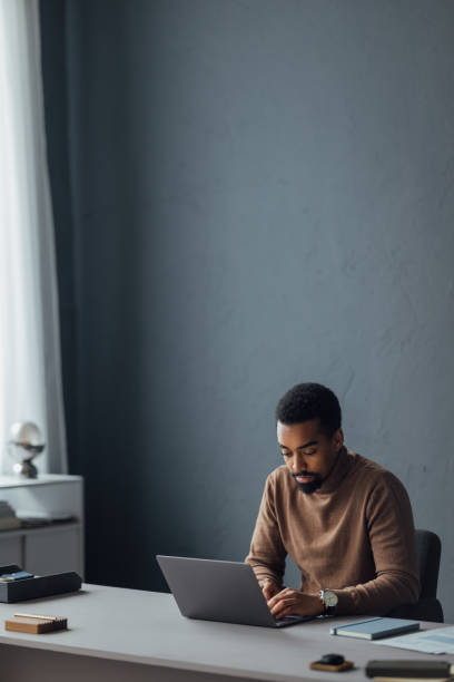 istock Focused Man Working Remotely on Laptop at Home Office 2170879149