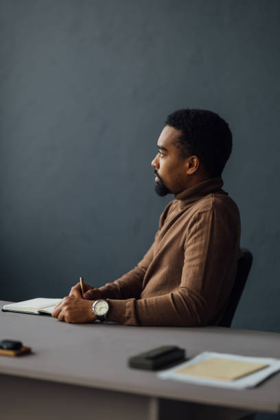istock Professional Man Deep In Thought At Office Desk 2170879152