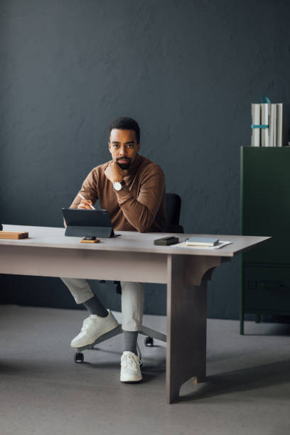 istock Focused Businessman Working on Tablet at Modern Office Desk 2170879193
