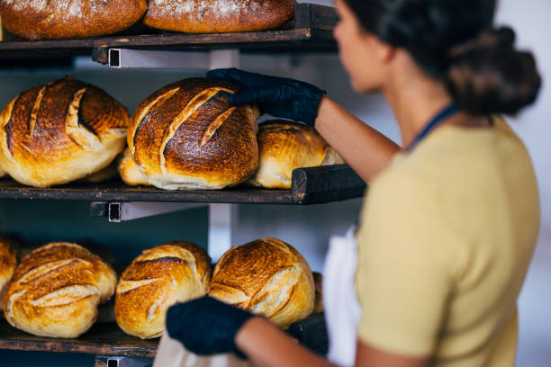 istock Baker Arranging Freshly Baked Artisan Bread on Shelves 2170880522