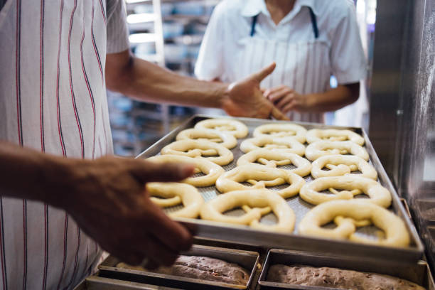 Hot delicious freshly baked soft pretzel stuffed with ham and cheese lies on counter at winter Christmas market. Perfect for Beer Fest or autumn festival. Great snack food.