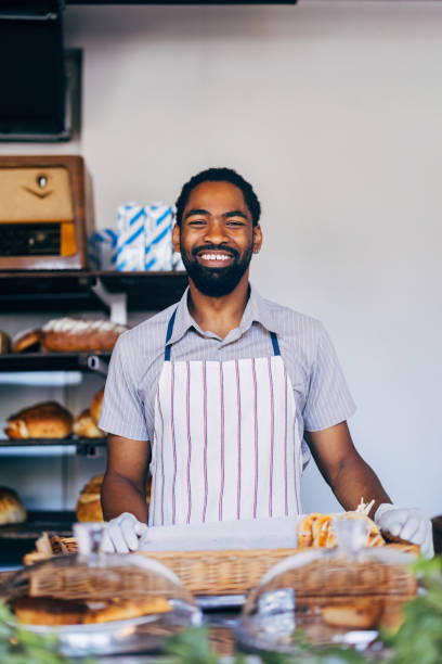 istock Smiling Baker in Apron Standing in Artisan Bakery Shop 2170880610