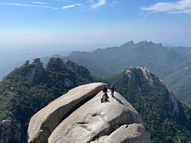 Seoul, Korea - August 31st 2024, Hikers taking a break on the Baegundae peak, Bukhansan National Park in Seoul Korea.