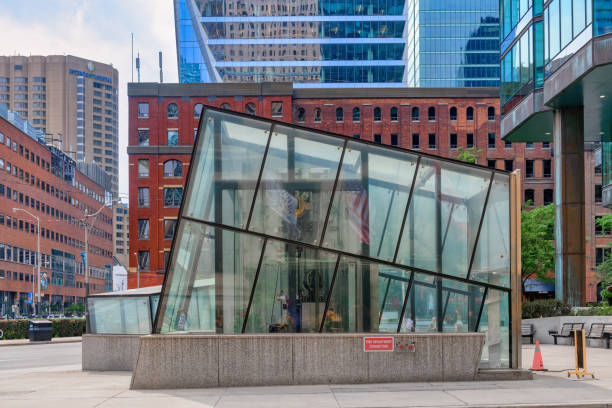 Toronto, Canada - September 10, 2024: A glass modern structure in the sidewalk. In the background, a colonial style brick-wall building. Urban architectural features
