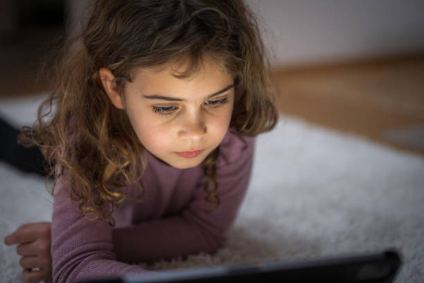 istock Young Girl Engaged with Tablet on Floor 2170885214