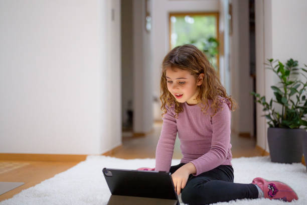 istock Young Girl Engrossed in Digital Learning on Tablet 2170885217