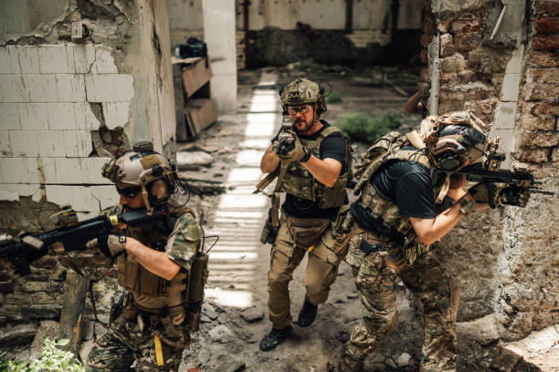 istock Air soft team in action at abandoned building shooting at opponent. 2170887355