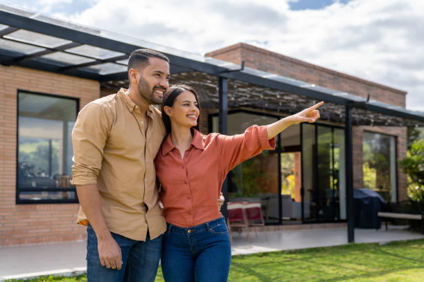 istock Couple in their back yard pointing away and smiling 2170888054