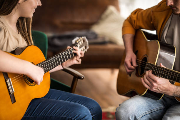 istock Caucasian Guitar Teacher Instructs Female Student 2170888467