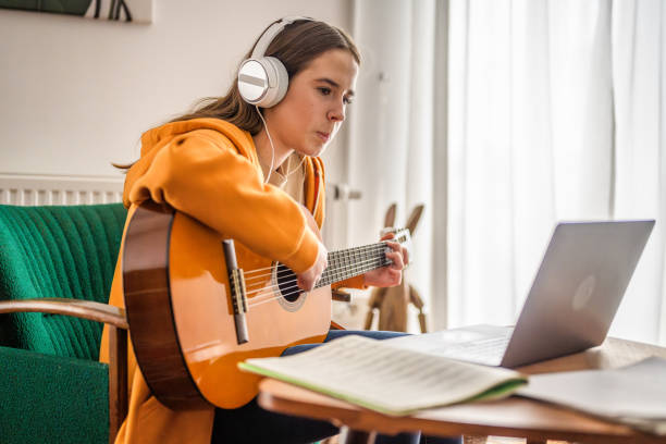 istock Caucasian Woman Practices Guitar Indoors 2170888469