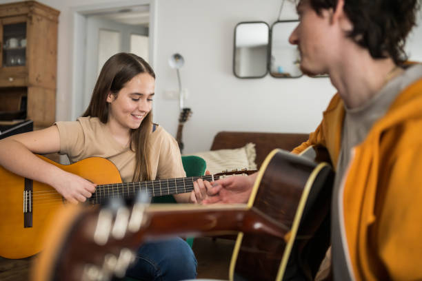 istock Guitar Lesson with Caucasian Instructor and Female Student 2170888472