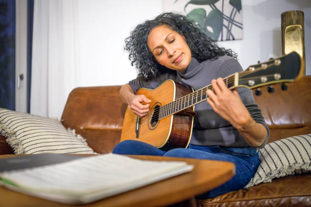 istock Caucasian Man Practices Guitar Chords Indoors 2170888508
