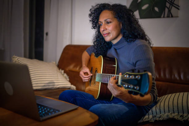 istock Beginner Guitar Practice for a Caucasian Man at Home 2170888512