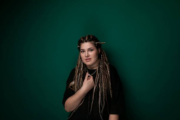 istock Woman With Dreadlocks Standing in Front of Green Wall 2170888520