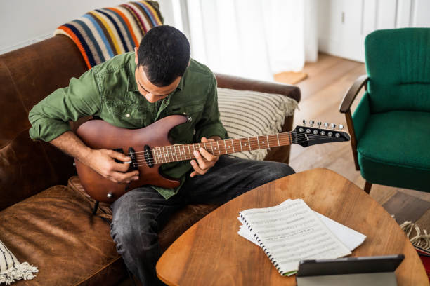 istock Musician Practices Guitar Riffs Indoors 2170888638