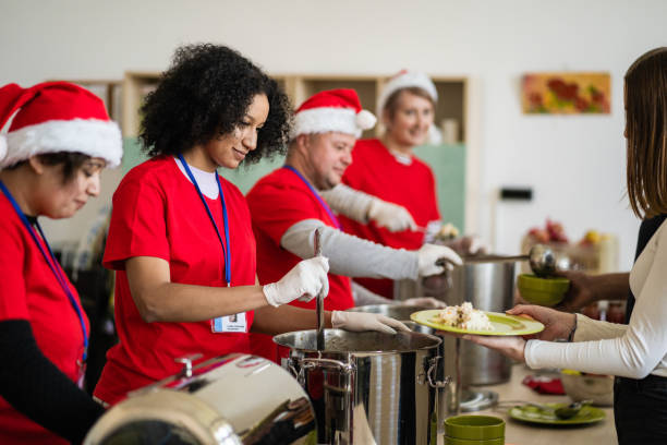 istock Friendly charity workers serving hot food in a soup kitchen 2170889382