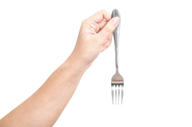 istock Female hand holding a silver steel fork isolated on white background. 2170893797