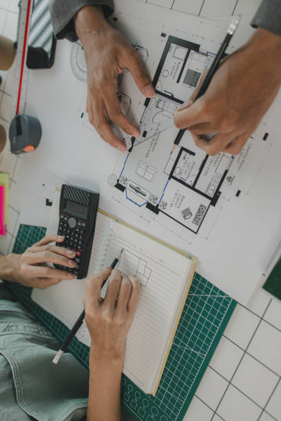 istock an architect and his assistant are brainstorming and examining the blueprints, two engineers are discussing a construction plan to make the structure stronger, draft, meeting, teamwork 2170894947