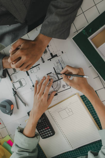 istock an architect and his assistant are brainstorming and examining the blueprints, two engineers are discussing a construction plan to make the structure stronger, draft, meeting, teamwork 2170894985