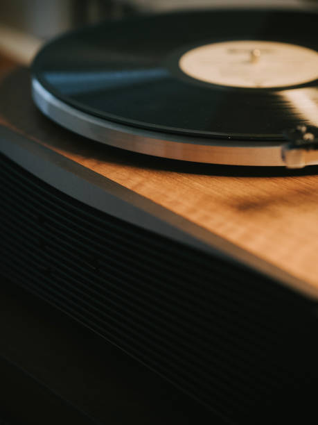 istock Turntable with vinyl record player illuminated in domestic room 2170898153