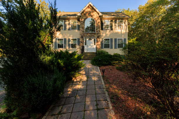 istock Nestled in Poconos forest. Two-story middle-class home with stone facade and beige siding 2170903513