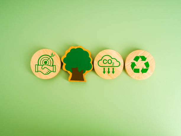istock Collaboration of carbon dioxide reduction, limit climate change concept. Cooperation success, handshake, reduce CO2 emissions, recycle icon, tree on round wood blocks, isolated on green background. 2170903692