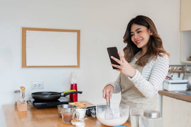 istock Woman Learning Baking Online, Culinary Exploration in Modern Kitchen 2170906794
