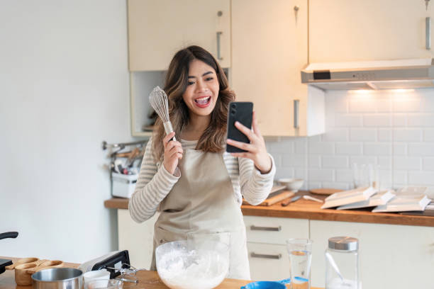 istock Woman Using Smartphone for Baking Lesson, Culinary Skills in Modern Kitchen 2170906813
