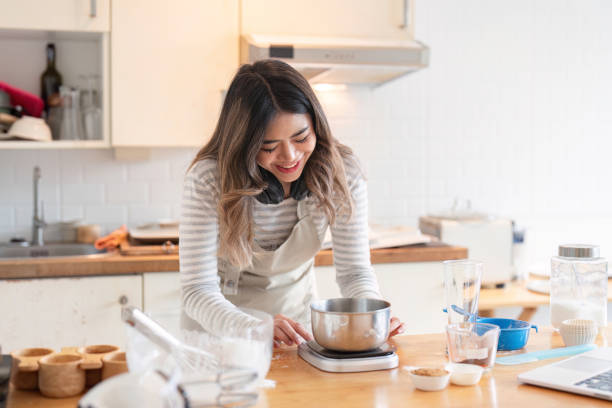 istock Smiling woman weighing ingredients in a modern kitchen 2170908782