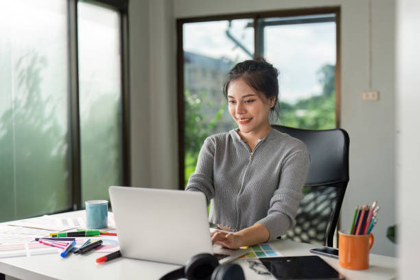 istock Young Female Designer Using Laptop with Bright Natural Light 2170908862