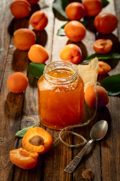 istock Apricot jam and fresh fruit on an old wooden table. 2170914089