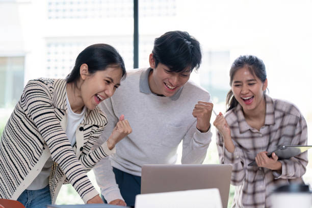 istock Cheerful Group Students Celebrating Success in Classroom 2170914245