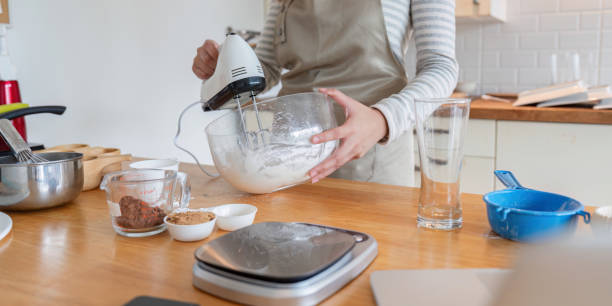 istock Woman Preparing Dessert with Mixer in Modern Kitchen 2170914459