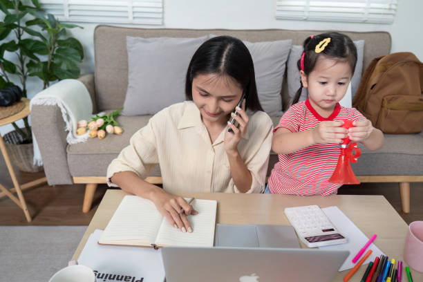 istock Multitasking Mother on Call While Child Plays Nearby 2170914725