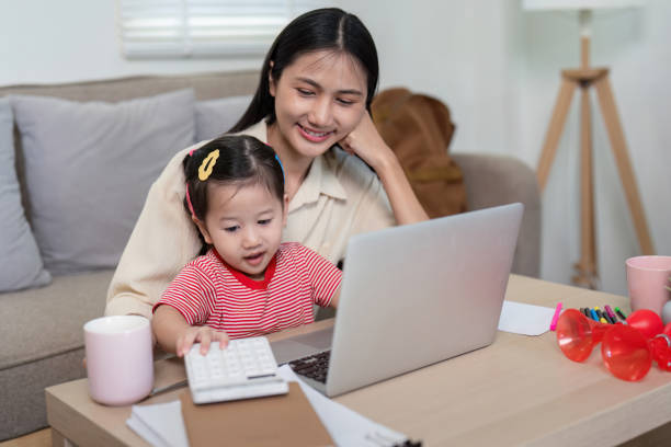 istock Curious Toddler Exploring the Laptop with Mother 2170914769